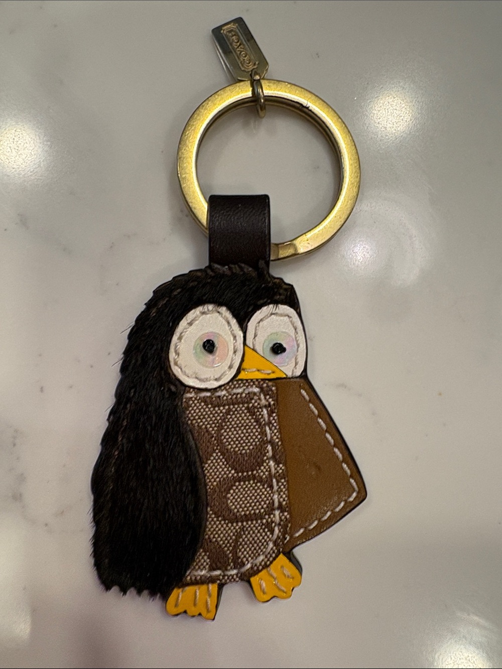 Coach Penguin Bag Charm in Black, Brown and Yellow